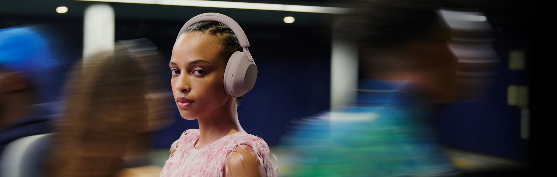 Woman enjoying peace and quiet with noise-canceling headphones in a cozy living room.